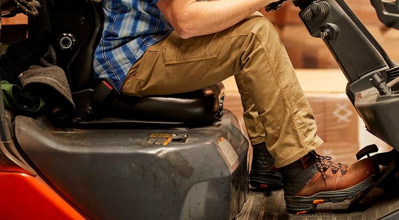 Ariat Rebar work boots and pants featured on a pallet jack